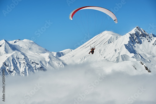 A man flying on a paraglider in the mountains of Georgia