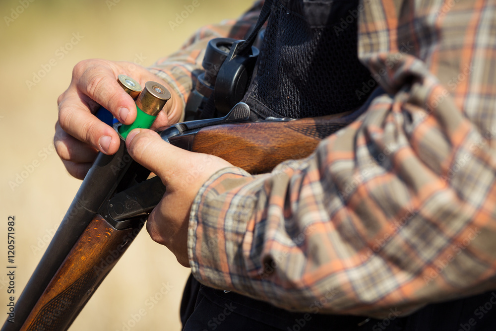 Close-up of a hunter loading his shotgun