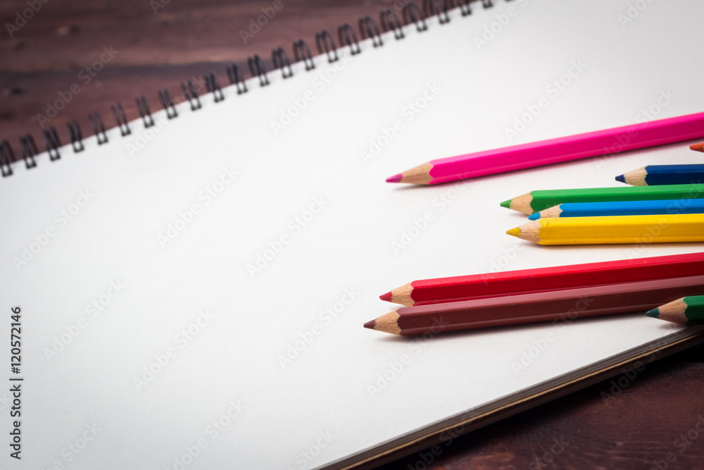 blank paper and colorful pencils on old wooden table with copy blank paper and colorful pencils on old wooden table with copy