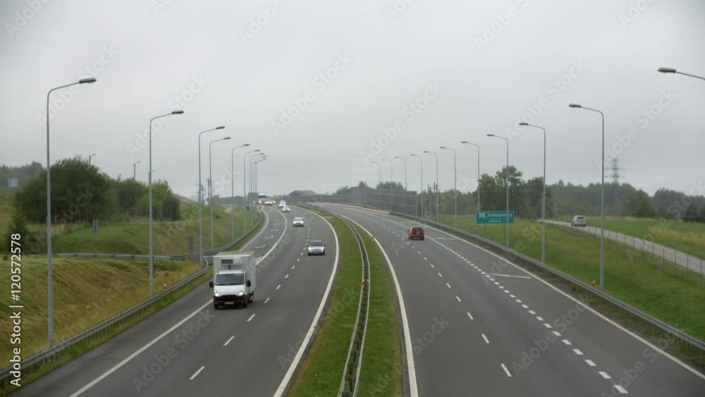 Cars passing on the highway rainy day