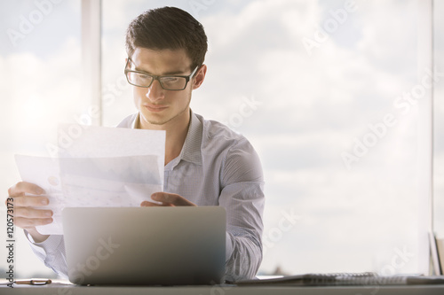 Man looking at business report