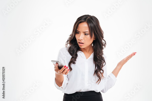 Disappointed confused asian businesswoman using smartphone