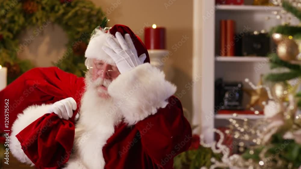Santa Claus waves and says 