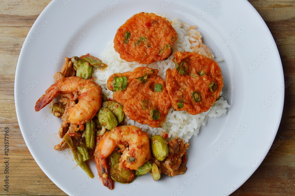 fried fish cake and spicy stir fried bitter flat bean with shrimp on rice fried fish cake and spicy stir fried bitter flat bean with shrimp on rice