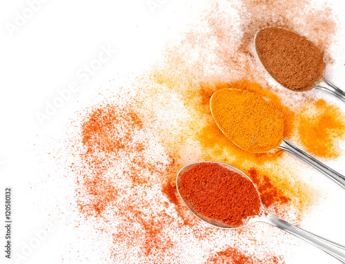 Fototapeta Naklejka Na Ścianę i Meble -  Different spices in spoons on white background