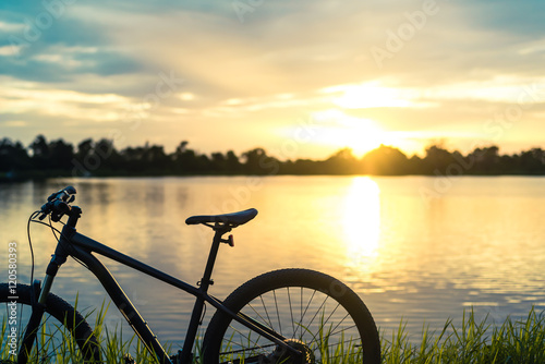 Silhouette Mountain bike sunset at river  © anatskwong