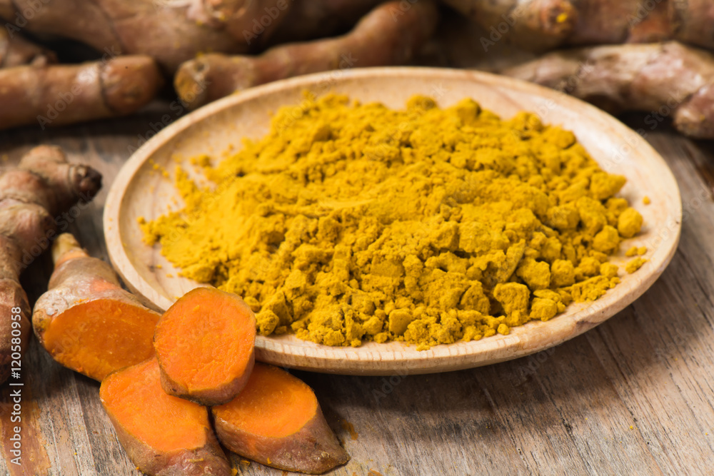 Fresh turmeric roots with turmeric powder Fresh turmeric roots with turmeric powder