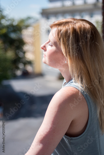 Portrait of a red haired woman enjoying the sun