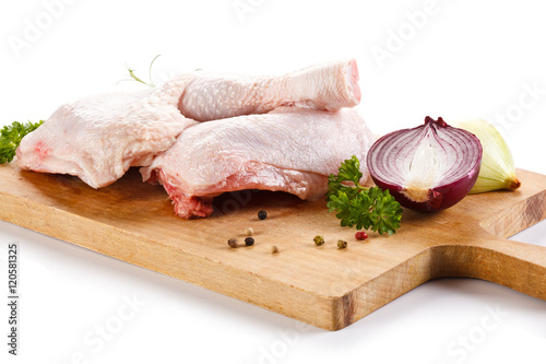 Raw chicken legs on cutting board 