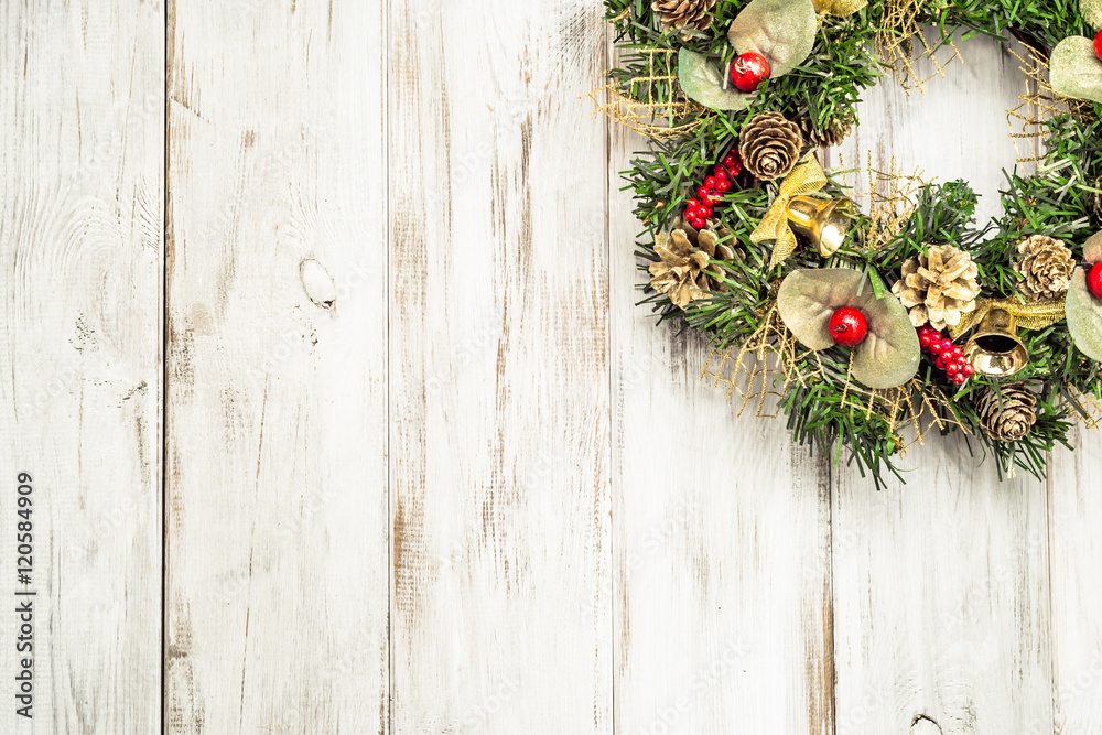 Christmas wreath hanging on wooden door, white background Christmas wreath hanging on wooden door, white background