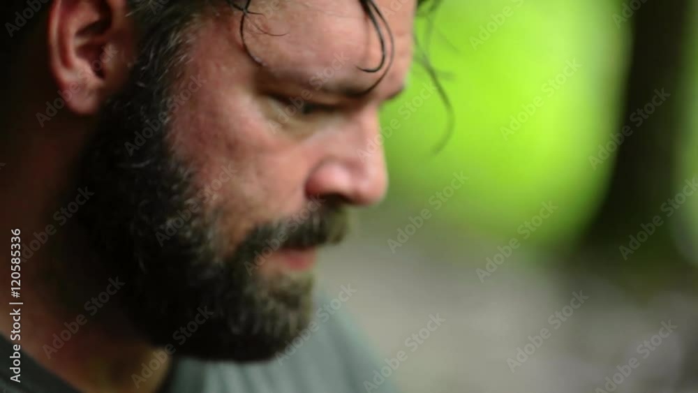 A man uses a magnetic navigational compass and map. Shallow focus.