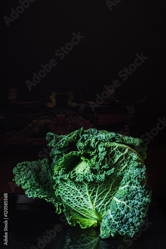 Bild auf Leinwand Savoy cabbage with vintage scale on dark background