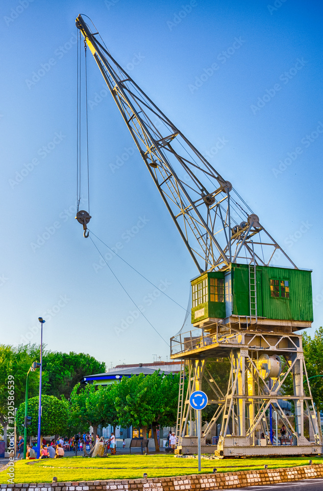 Naklejka premium Old crane transformed in a monument in port of Tarragona, Spain