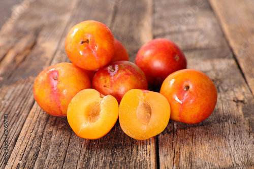 fresh plum on wood background
