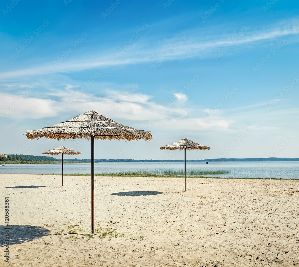 .Sunshades on the beach at the lake.