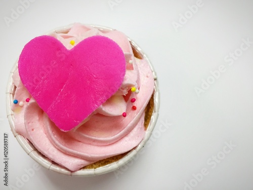 Pink cupcake with pink whipping cream and pink paper cup 