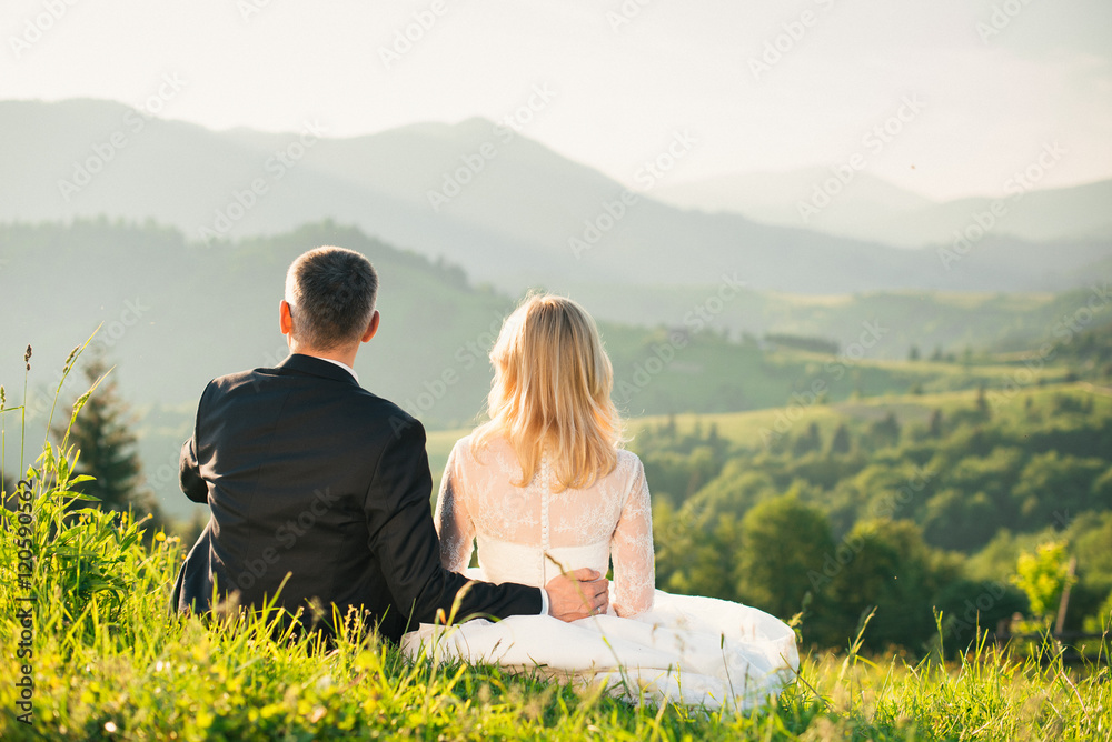 Groom shows bride the beautiful views of the mountains during honeymoon