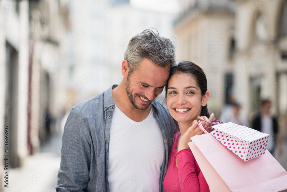 A trendy couple walking and doing shopping in the city