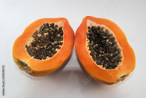 Papaya cut in half on white background