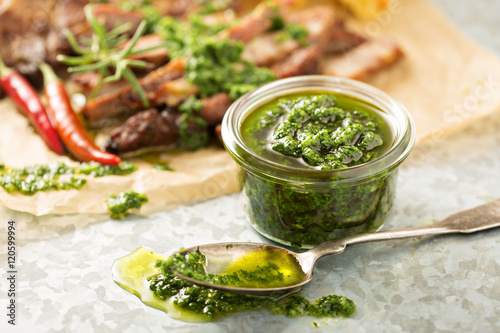 Green chimichurri sauce with grilled steak photo