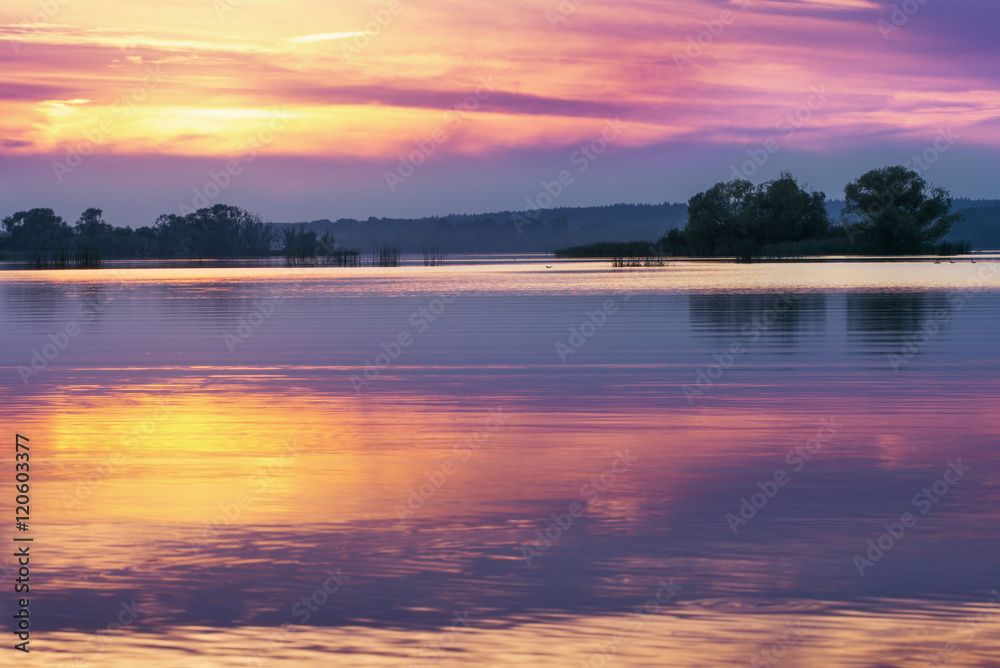 Sunset on lake in summer evening