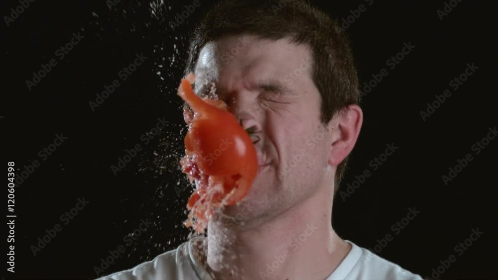Slow motion shot of tomato hitting man in face, shot on Phantom Flex at 2000 fps