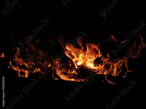 Burning fireplace with fire flames on black background