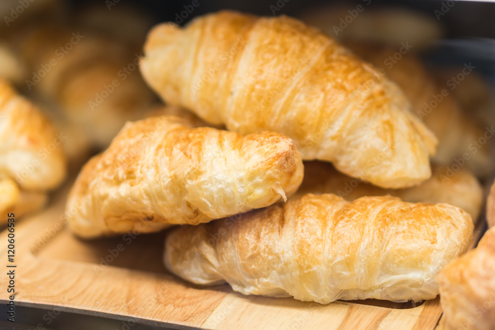 Tasty croissants on grey wooden background Tasty croissants on grey wooden background
