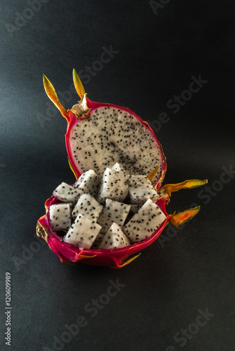 Dragon fruit served for a dessert on black background