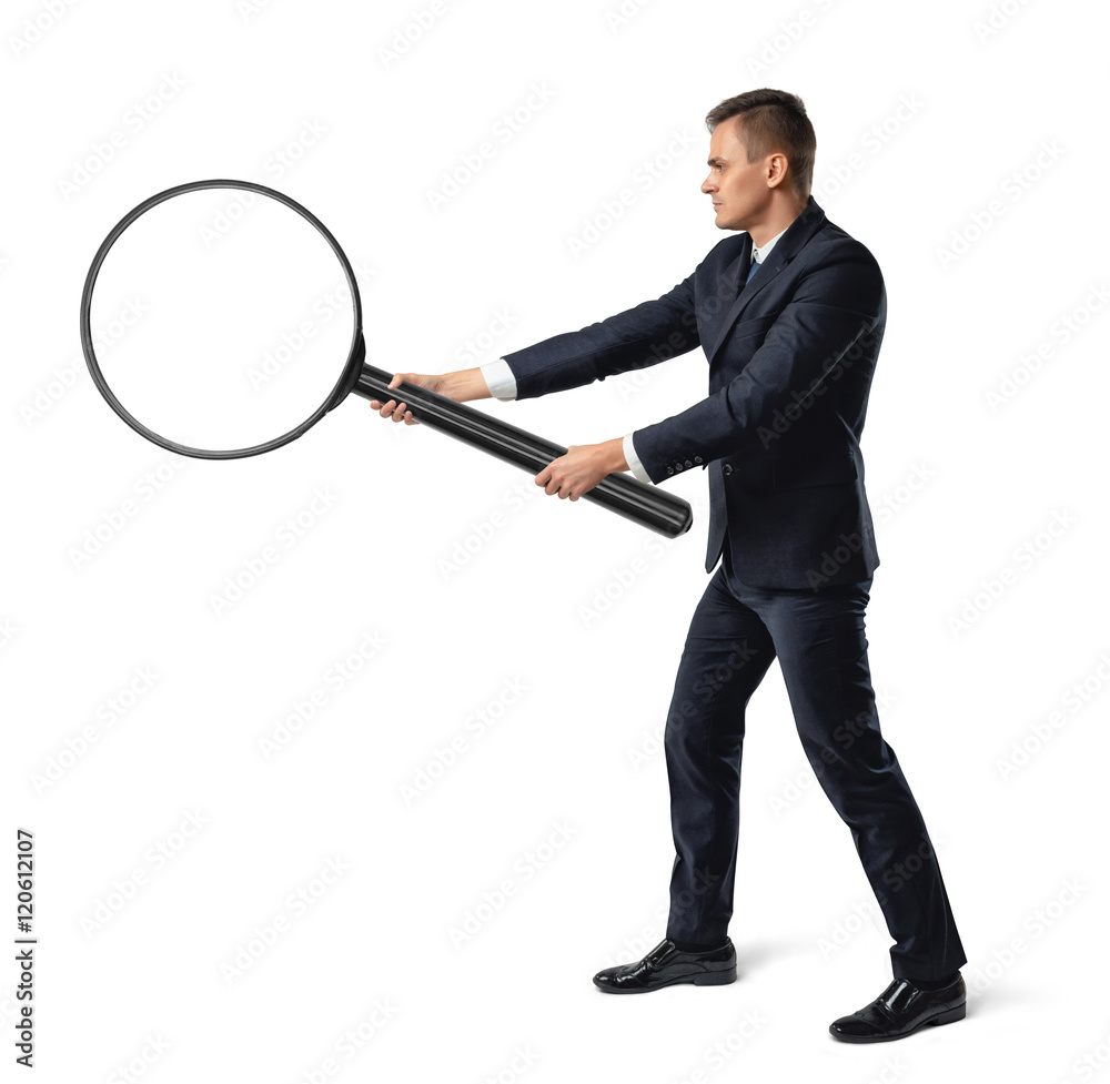 Side view of a businessman holding big magnifier with both hands isolated on white background Side view of a businessman holding big magnifier with both hands isolated on white background