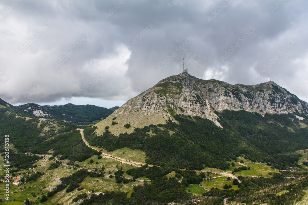 View of mountain ridge and cloudy gray dramatic sky in the summer. Lovcen national park.  Montenegro. Europe.