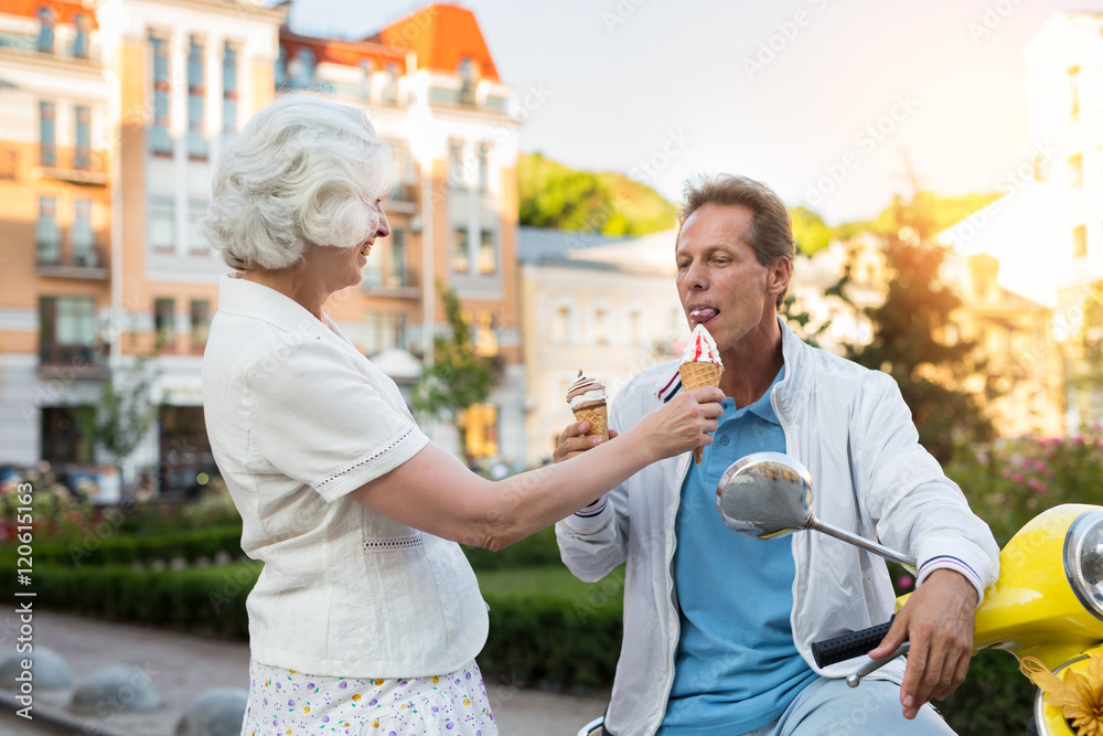 Adult man eats ice cream. Couple on street background. Let's make a short break. Trip to europe in summer.