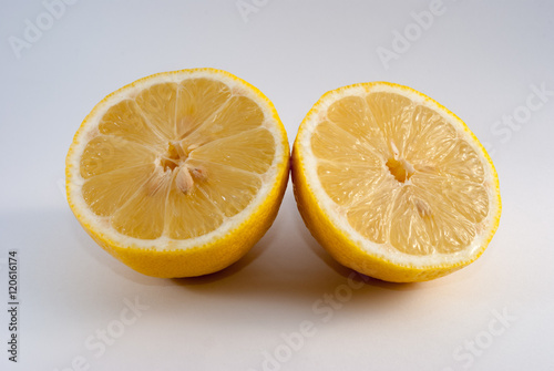 Lemon cut in half on white background