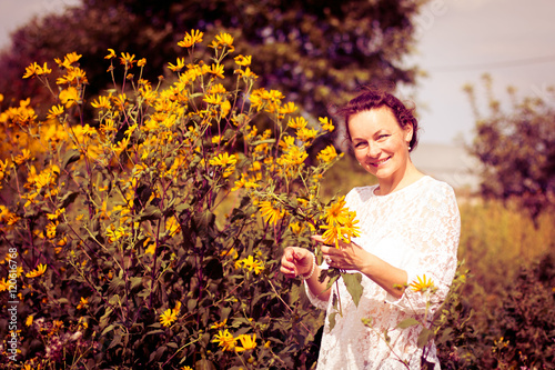 Nice girl and flowers in a nice day photo