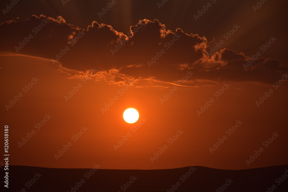 time laps of sunset and orange sunrise over the mountains. Orange gradation of sunset cloudy sky over the silhouette of mountain range time laps of sunset and orange sunrise over the mountains. Orange gradation of sunset cloudy sky over the silhouette of mountain range