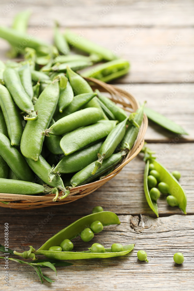 Green peas on a grey wooden table Green peas on a grey wooden table