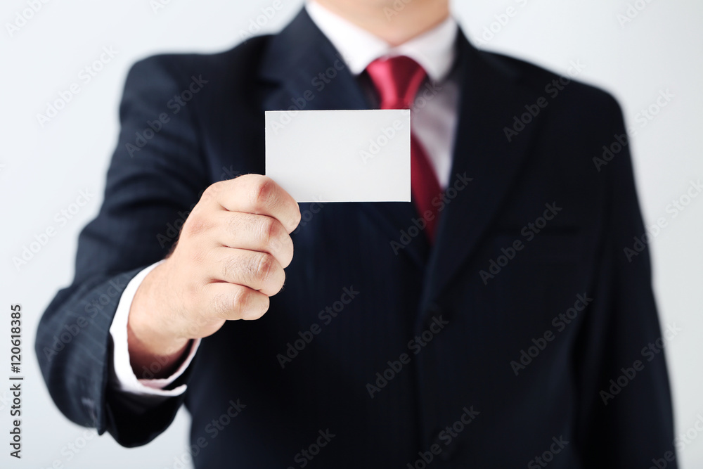 Businessman holding blank card in his hand Businessman holding blank card in his hand