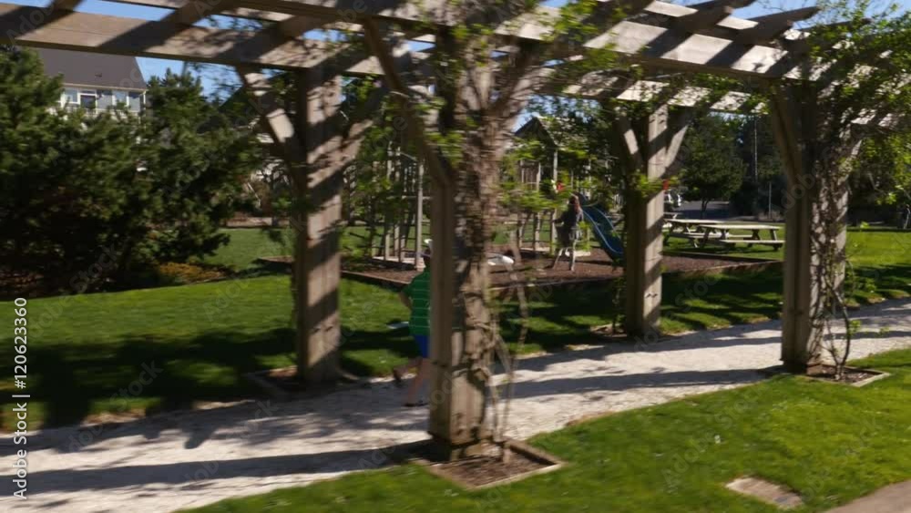 Boy running through park with toy airplane Boy running through park with toy airplane