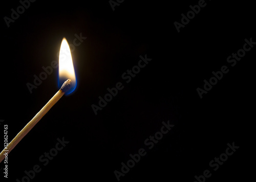 Burning match. A photo close up, a dark background