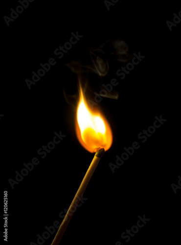 Bright flash sulfur match on a dark background. Beautiful fire close-up.