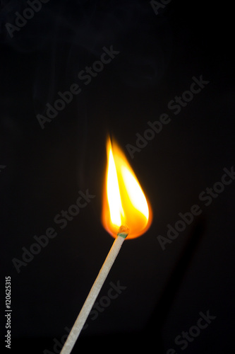 Bright flash sulfur match on a dark background. Beautiful fire close-up.