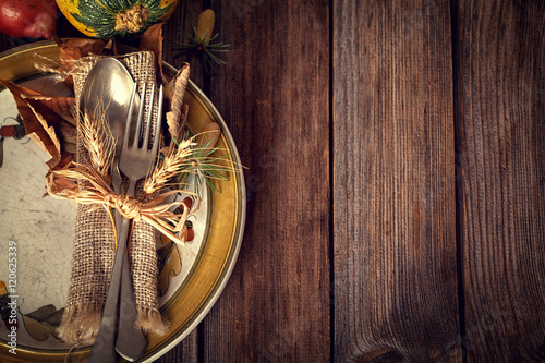 Autumn place setting - on rustic wooden table  photo