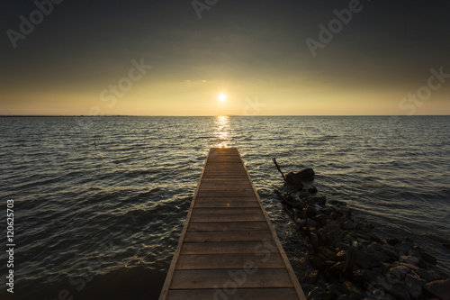 Empty pontoon over a lake at sunrise