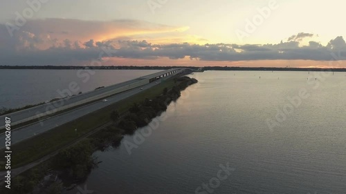Wallpaper Mural Aerial pan of car driving over Florida inter coastal bridge into the sunset. Torontodigital.ca