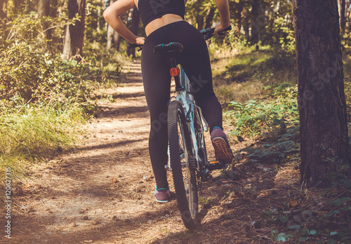 Woman riding a bicycle in the forest