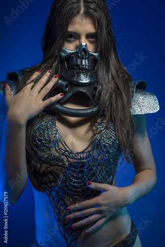 pretty girl with iron armor and metal skull, sensual dark and da photo