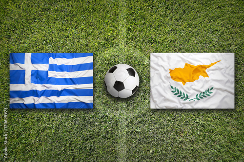 Greece and Cyprus flags on soccer field