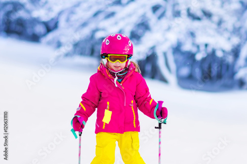 Little girl skiing in the mountains