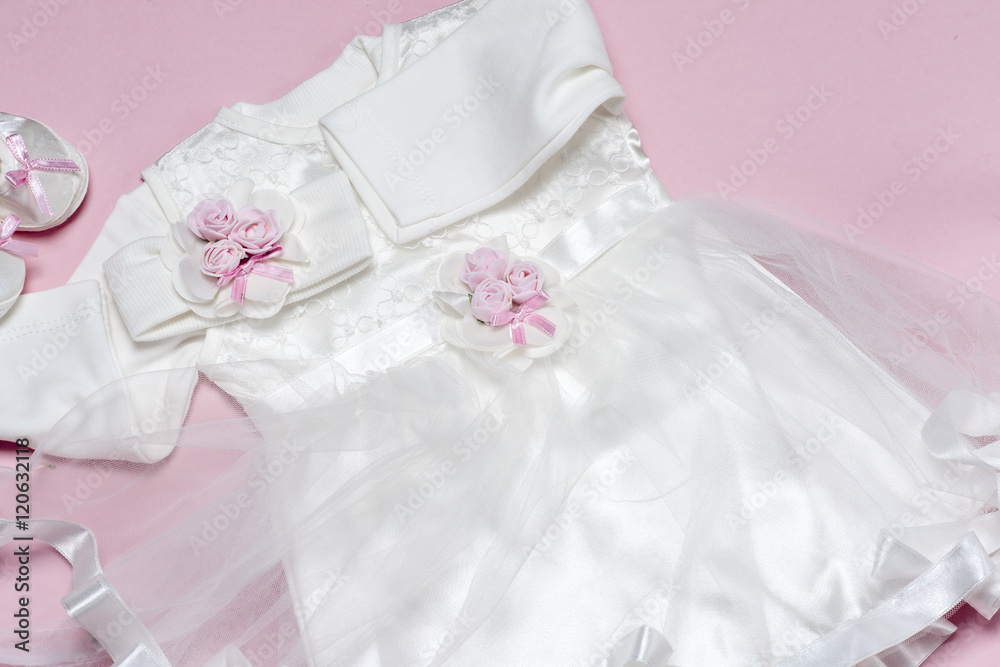 Clothes for baby girl on a pink background. Copy space Clothes for baby girl on a pink background. Copy space