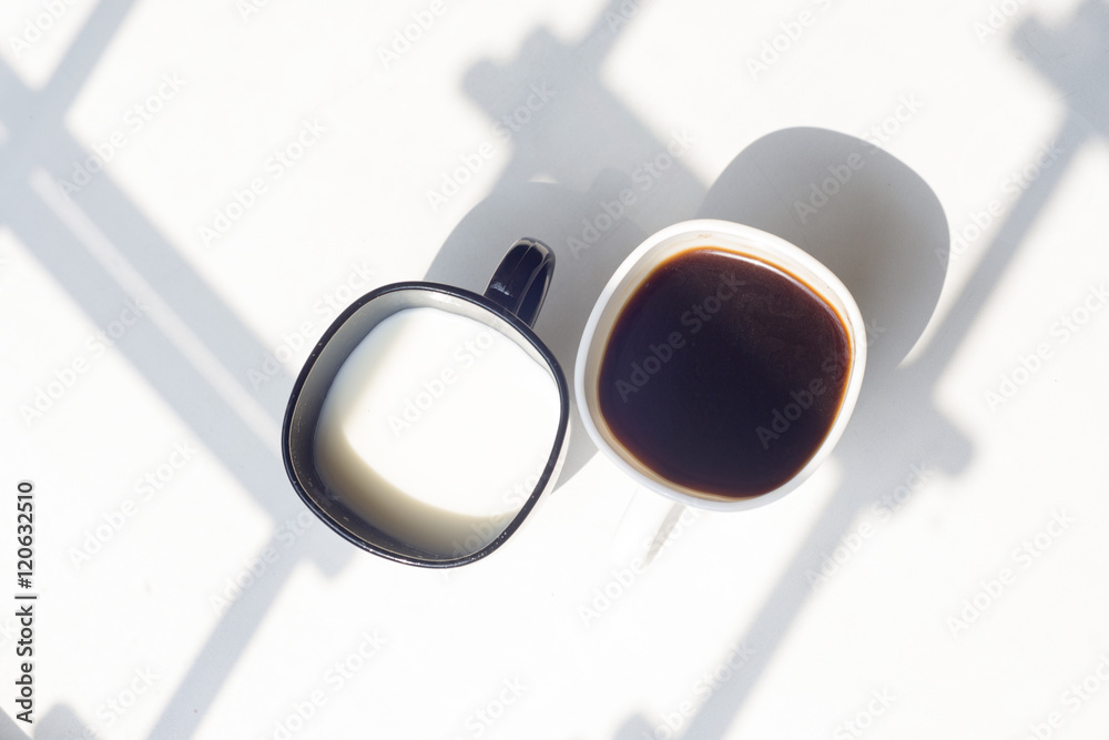 black and white cup of milk, coffee on natural background, top view